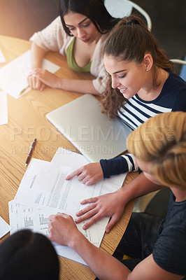 Buy stock photo Notes, students and women at table for studying, research and session in cafeteria. Study group, papers and documents for learning together in college for education, progress and knowledge for exams