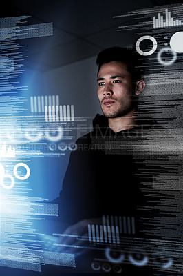 Buy stock photo Shot of a focussed computer programmer working at his computer late at night