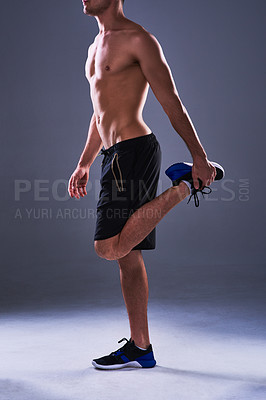 Buy stock photo Stretching, legs and man in studio for fitness, wellness and training or balance for workout. Body care, athlete and warm up or start for exercise and performance with flexibility by gray background