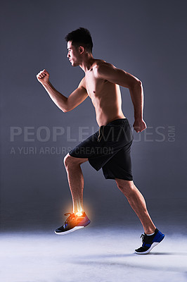 Buy stock photo Man, ankle and injury of fitness in studio, anatomy of leg or foot and xray for diagnosis. Red glow, running and person with inflammation of muscle strain, tension or ache and gray background.