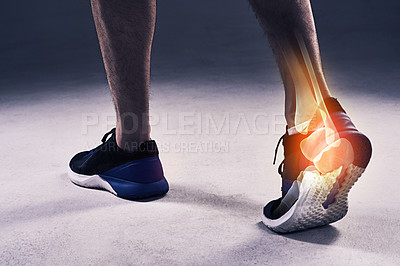 Buy stock photo Cropped shot of a young man in the studio with cgi highlighting his ankle injury