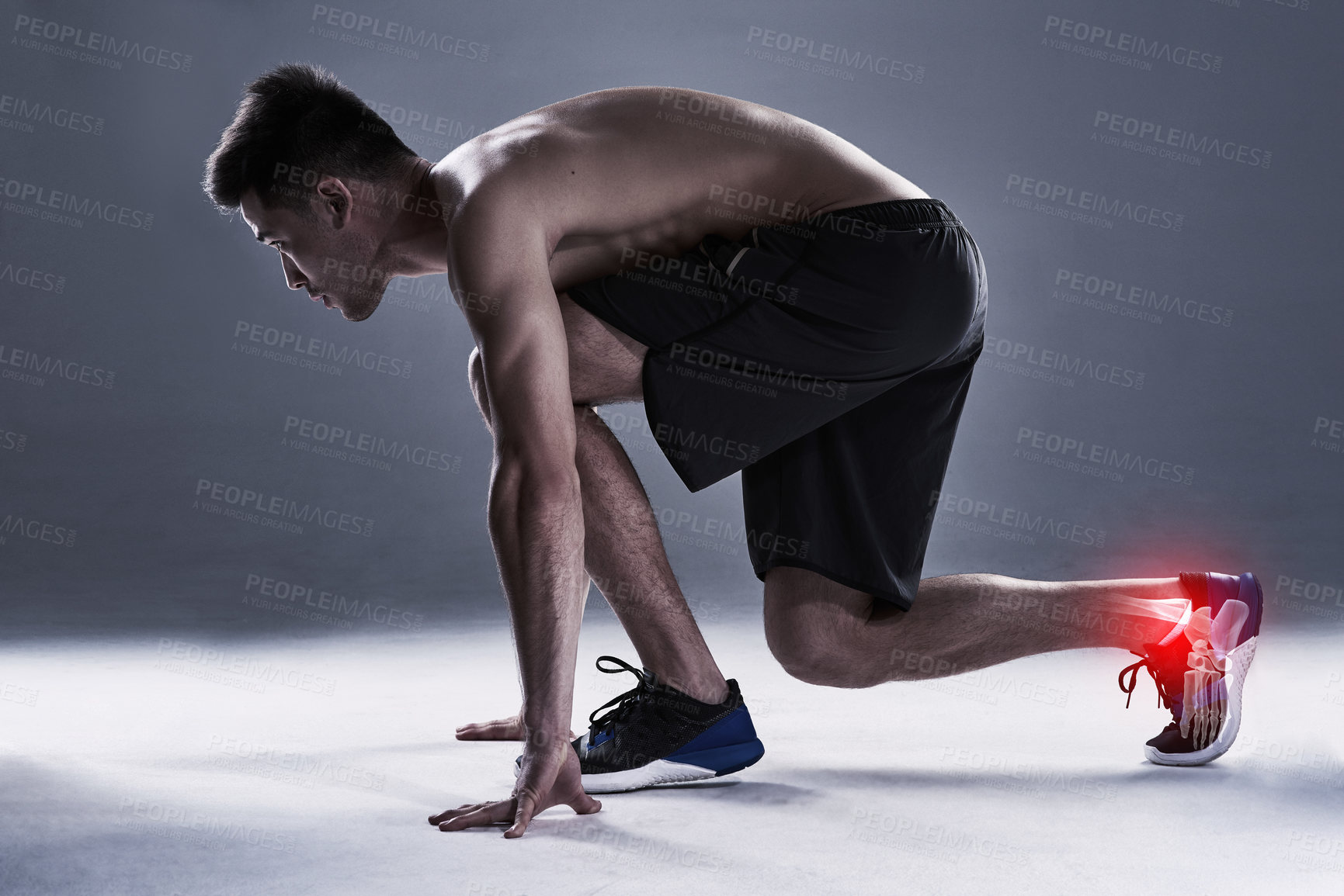 Buy stock photo Full length shot of a young man in the studio with cgi highlighting his ankle injury