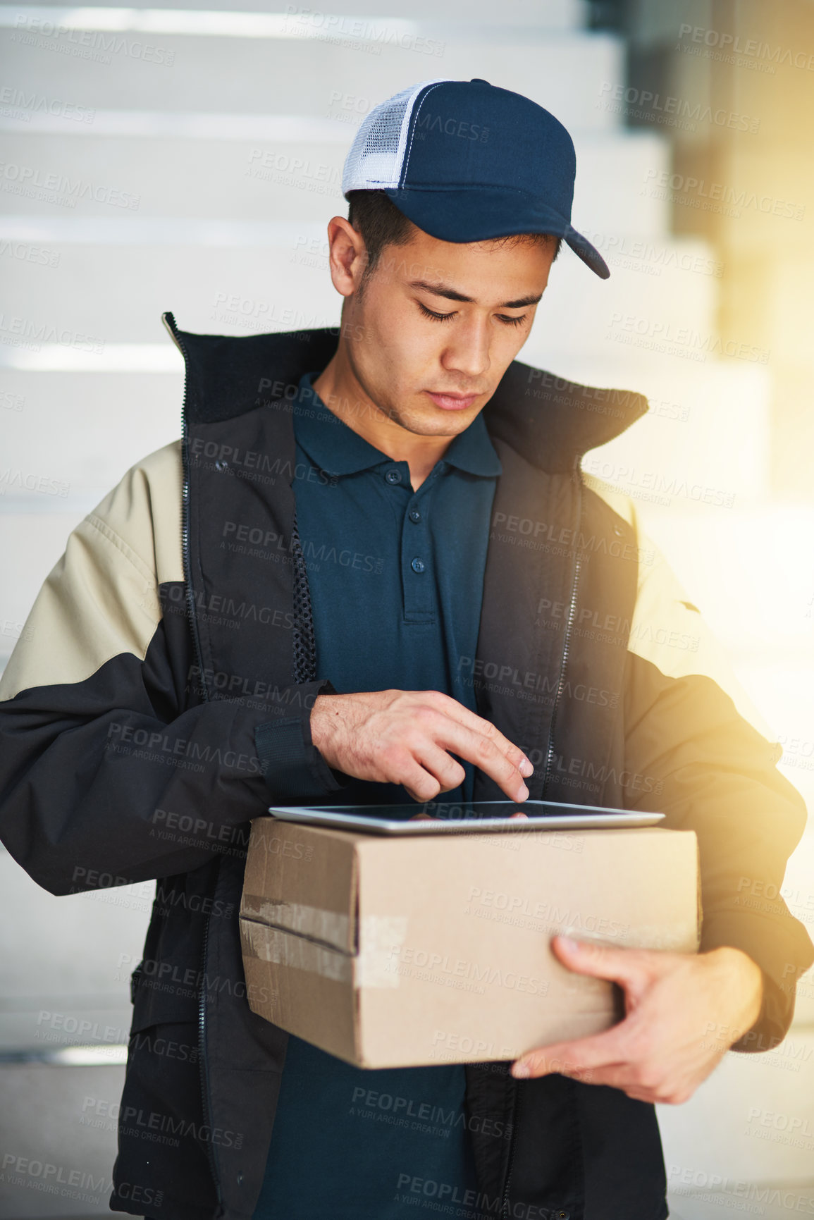 Buy stock photo Cropped shot of a courier using a digital tablet while making a delivery in an office