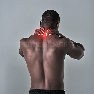 Buy stock photo Rearview shot of an athletic young man holding his neck in pain
