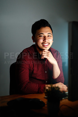 Buy stock photo Portrait of a young male designer working on his computer late at night