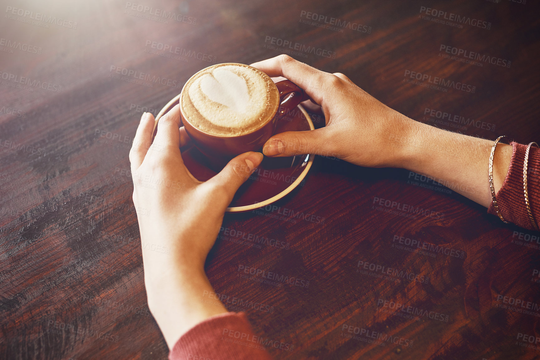 Buy stock photo Closeup shot of an unidentifiable woman enjoying a cup of coffee in a cafe