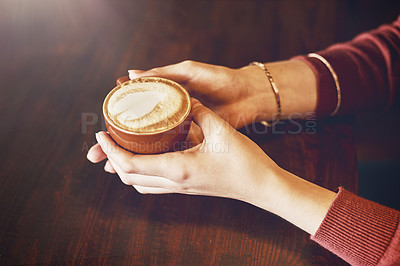Buy stock photo Closeup shot of an unidentifiable woman enjoying a cup of coffee in a cafe