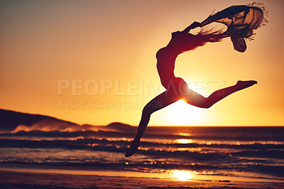 Buy stock photo Silhouette of an energetic woman jumping on the beach at sunset