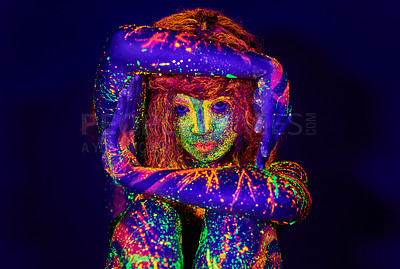 Buy stock photo Cropped portrait of a young woman posing with neon paint on her face