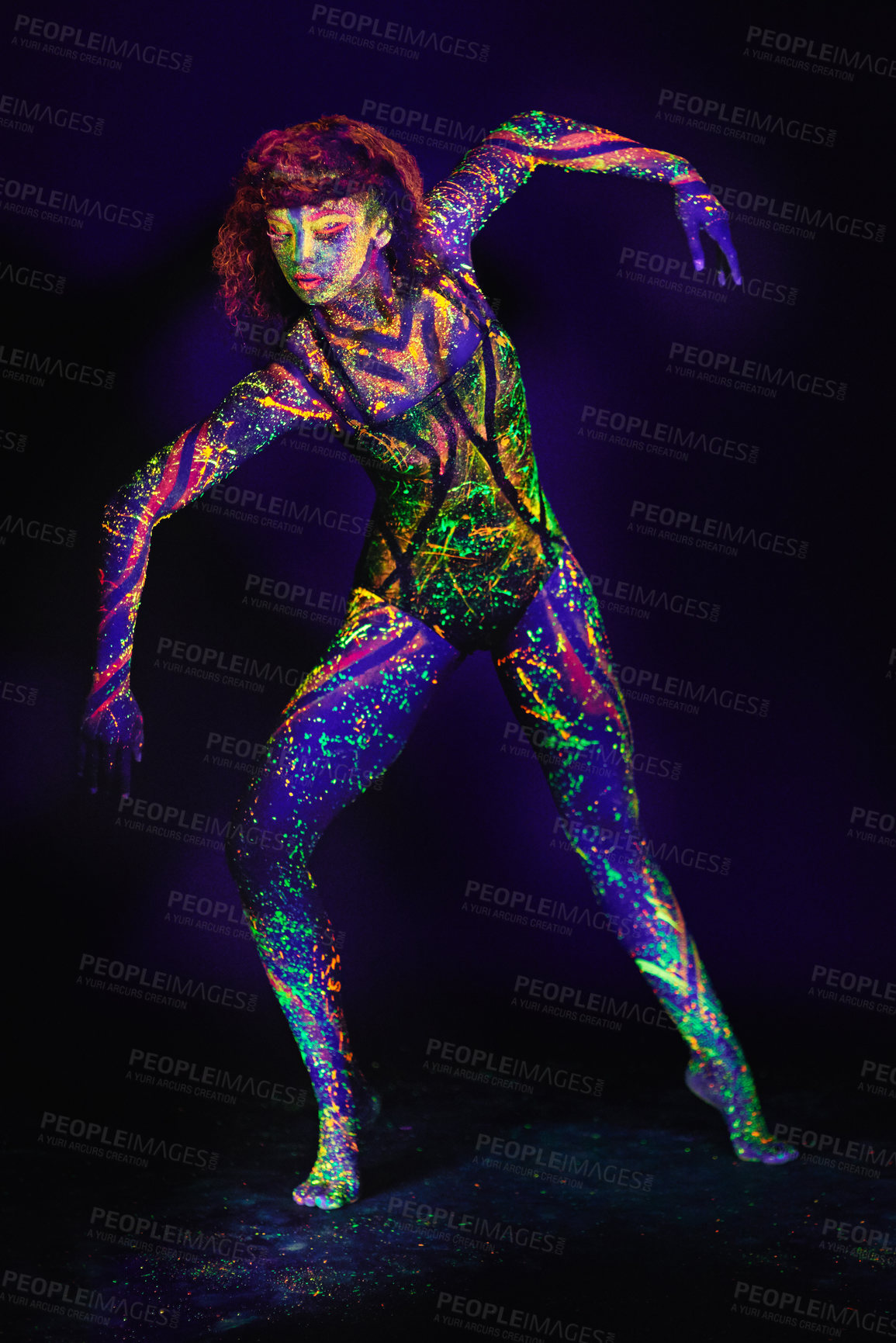 Buy stock photo Full length shot of a young woman posing with neon paint on her face