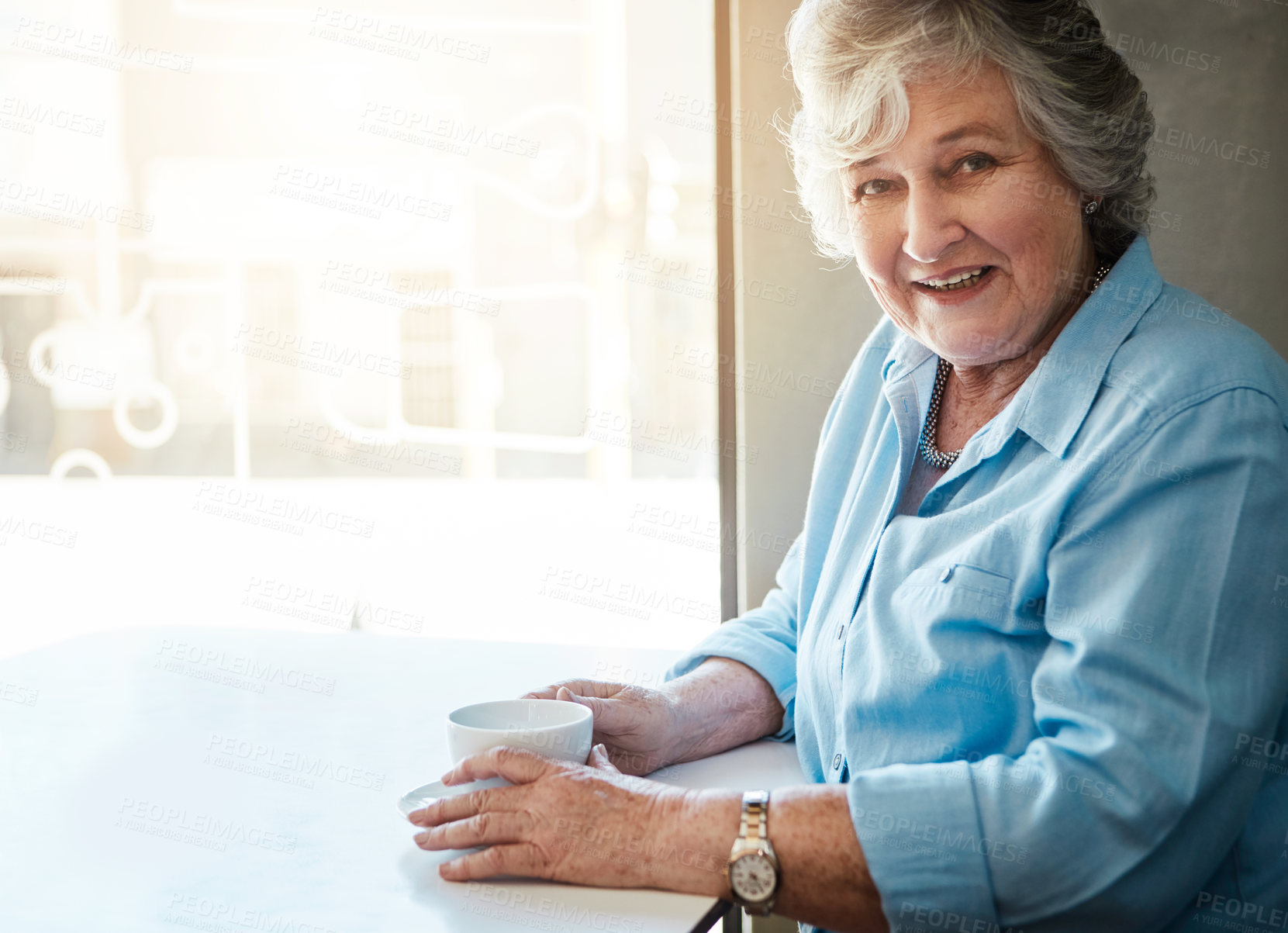 Buy stock photo Shot of a senior woman sitting in a cafe