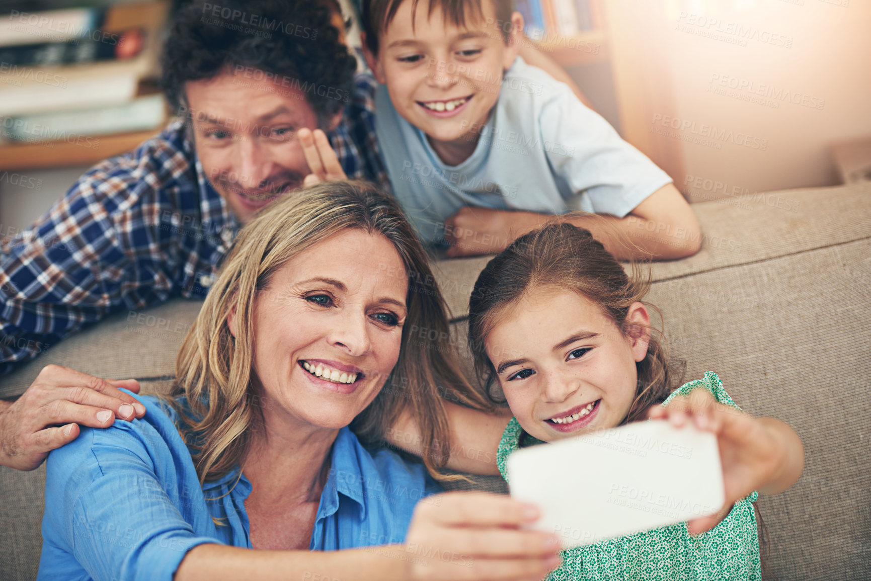 Buy stock photo Happy family, relax and selfie with peace sign on sofa for memory, picture or bonding together at home. Mom, dad and young children with smile for photography, capture or moment on living room couch