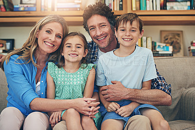 Buy stock photo Portrait of a happy family relaxing on the sofa together at home