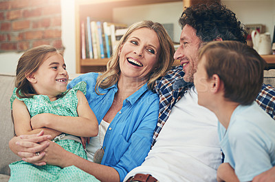 Buy stock photo Shot of a happy family relaxing on the sofa together at home
