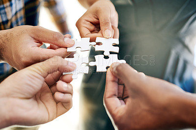 Buy stock photo Cropped shot of a work group connecting pieces of a puzzle