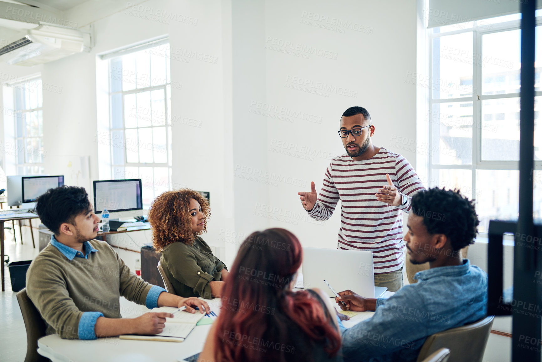 Buy stock photo Shot of a group of colleagues having a meeting in a modern office