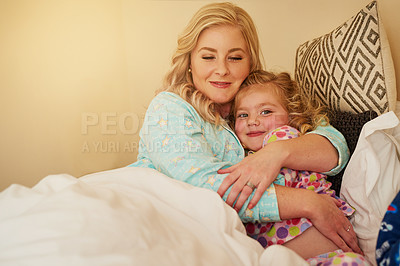 Buy stock photo Cropped shot of a mother bonding with her little daughter in bed at home