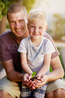 Buy stock photo Portrait of a father and his little son holding a plant growing out of soil