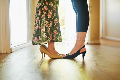 Buy stock photo Cropped shot of a mother and her little daughter wearing high heels at home