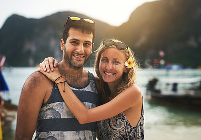 Buy stock photo Portrait of a young couple enjoying a day at the beach together