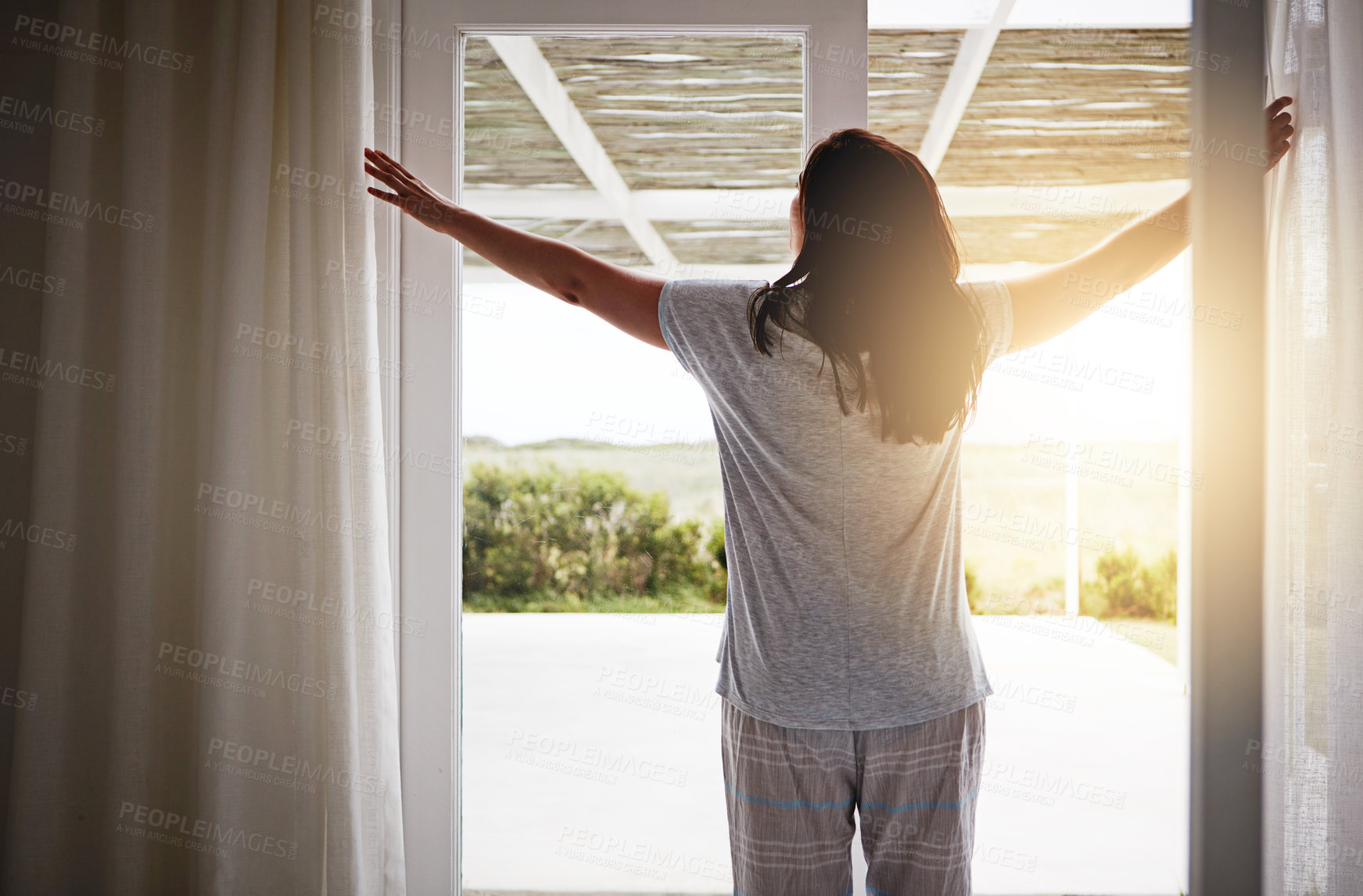 Buy stock photo Back, woman and open drapes in morning, window and fresh wake up with sunrise in hotel ready for day. Routine, outside view and nature on holiday or weekend, curtain and light in apartment in bedroom