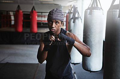 Buy stock photo Fitness, punching and portrait of black man in MMA gym for boxing, challenge or competition training. Power, muscle and champion boxer at workout with confidence, fight and energy in sports club.