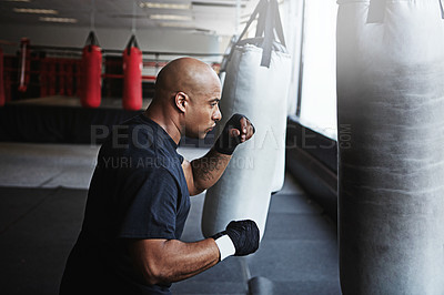 Buy stock photo Fitness, punching bag and man in MMA gym for boxing, challenge or competition training. Power, muscle and serious champion boxer at workout with confidence, fight and energy in sports exercise club.