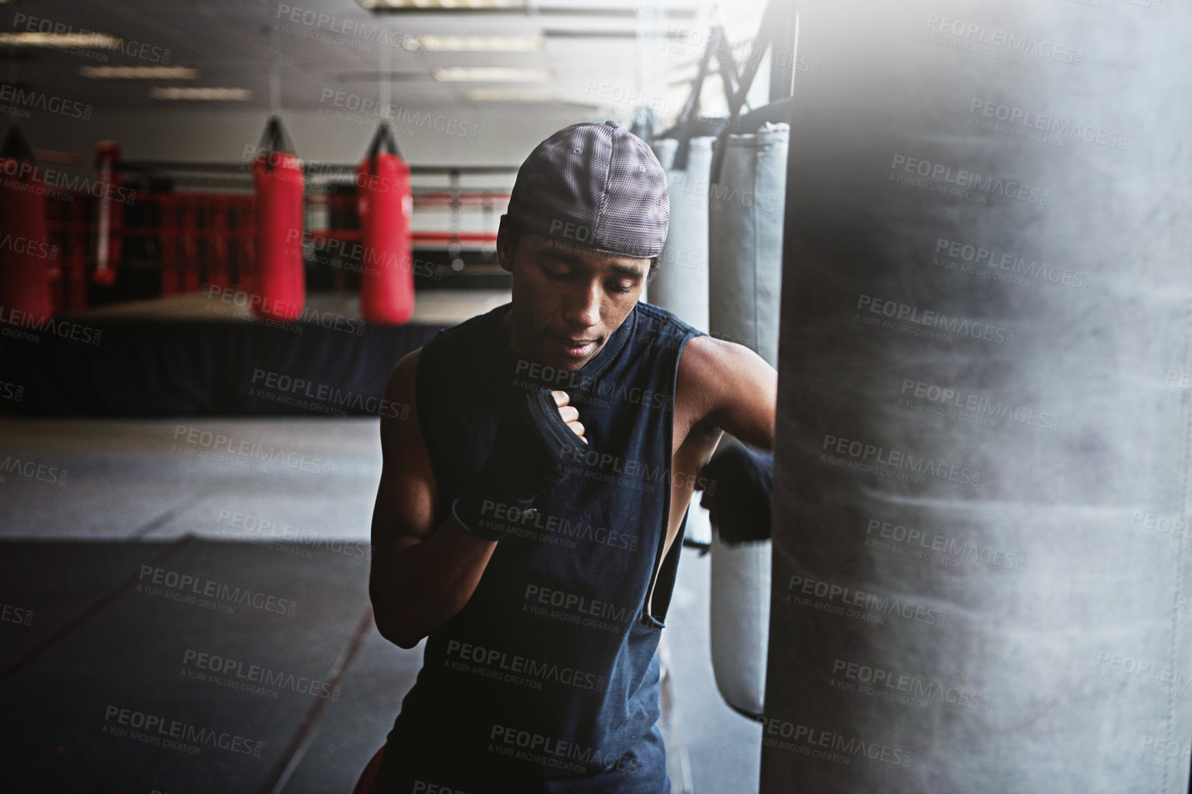 Buy stock photo Fitness, punching bag and black man in MMA gym for boxing, challenge or competition training. Power, muscle and champion boxer at workout with confidence, fight and energy in sports exercise club.