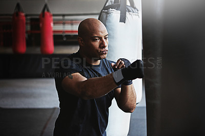 Buy stock photo Fitness, punching bag and man in MMA challenge for boxing, gym or competition training. Power, muscle and serious champion boxer at workout with confidence, fight and energy in sports exercise club.