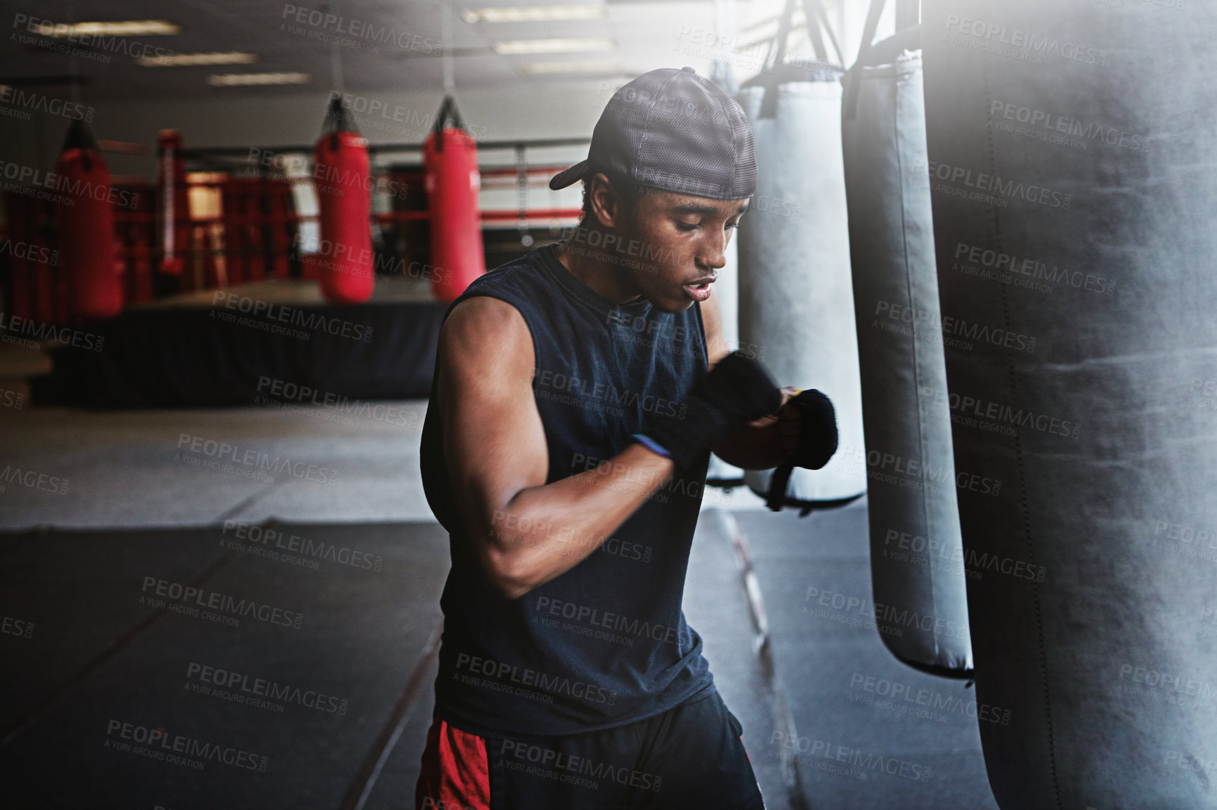 Buy stock photo Fitness, punching bag and black man in boxing gym for MMA, challenge or competition training. Power, muscle and champion boxer at workout with confidence, fight and energy in sports exercise club.