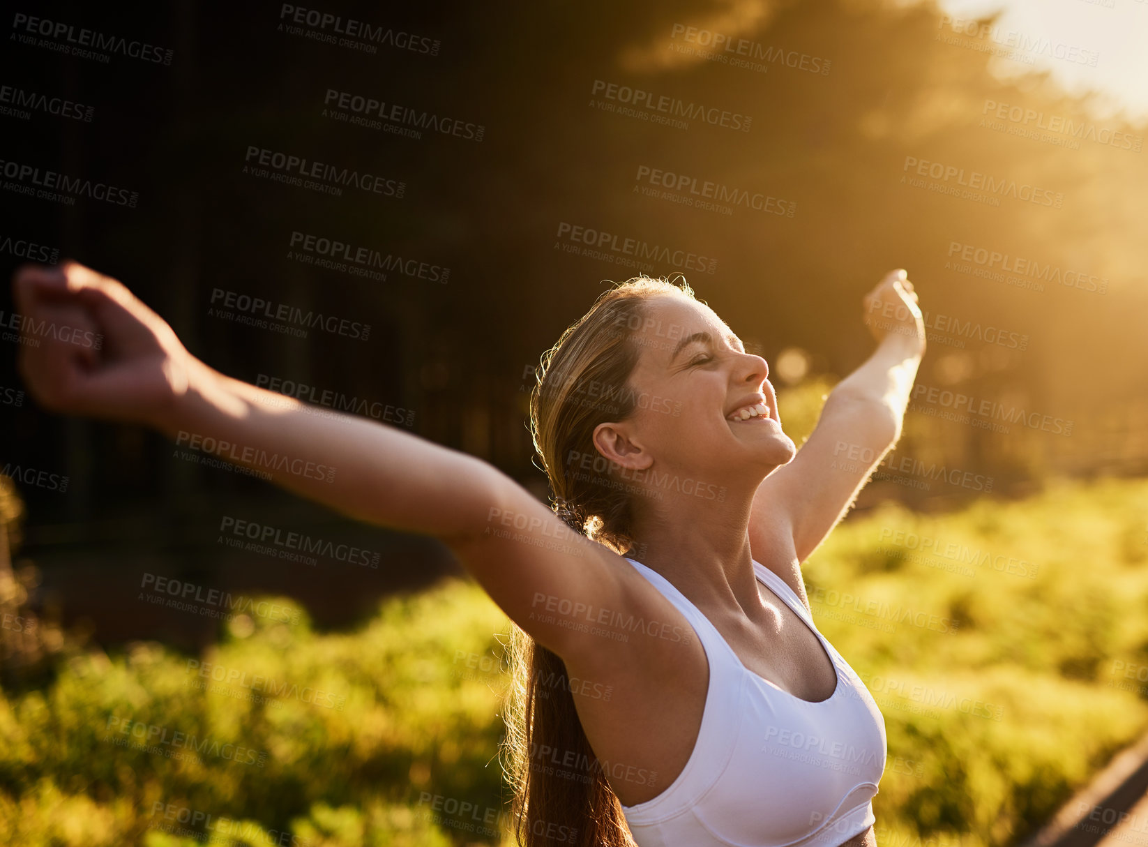 Buy stock photo Shot of a happy young woman out for a run in nature