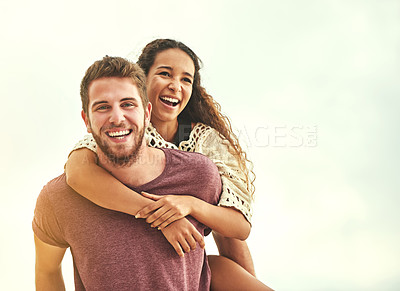 Buy stock photo Cropped portrait of an affectionate young couple enjoying their time on the beach