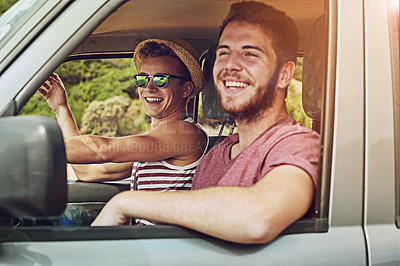 Buy stock photo Cropped shot of two young friends enjoying a roadtrip together