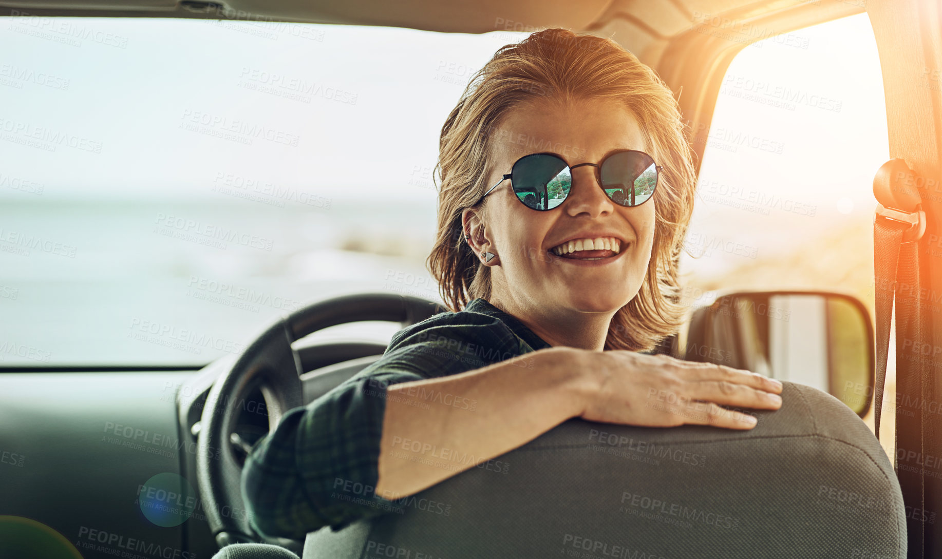 Buy stock photo Portrait of a young woman enjoying a roadtrip