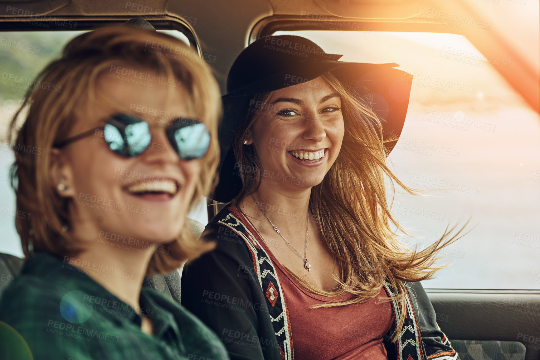 Buy stock photo Portrait of two young friends enjoying a roadtrip together
