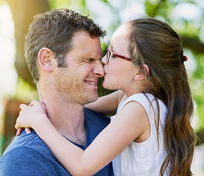 Buy stock photo Cropped shot of a little girl giving her father a kiss outside
