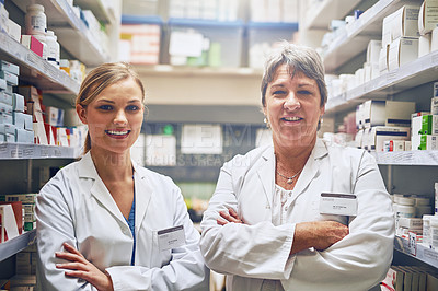 Buy stock photo Portrait of pharmacists standing in a isle with their arms crossed