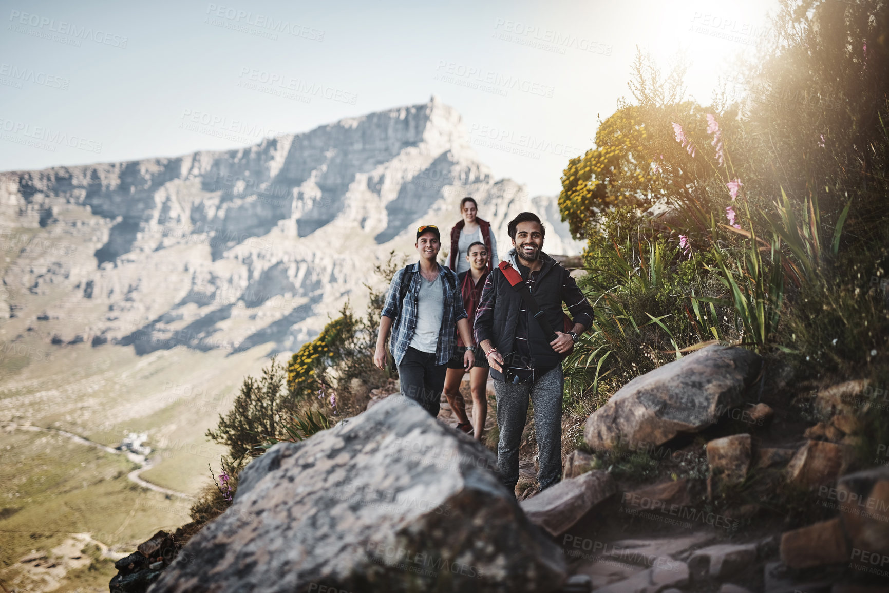 Buy stock photo Full length shot of a group of friends walking along a mountain trail