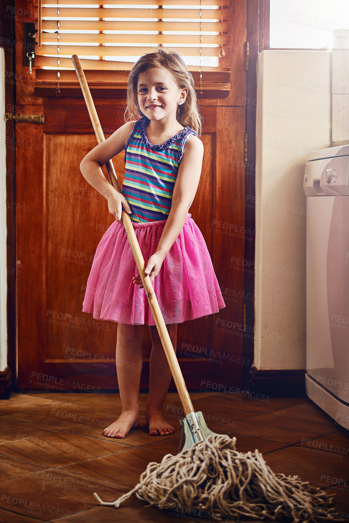 Buy stock photo Portrait of a little girl mopping the floor at home