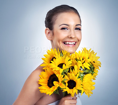 Buy stock photo Studio portrait of a beautiful young model posing against a blue background