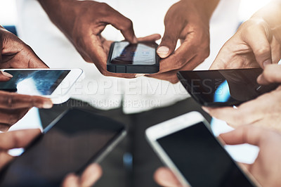 Buy stock photo Cropped shot of a group of people using their smart phones in synchronicity