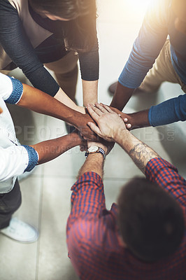 Buy stock photo Cropped shot of a work group joining hands in solidarity