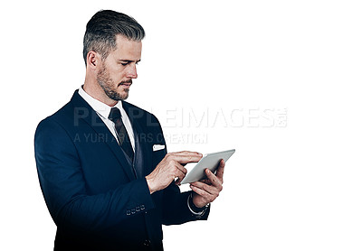 Buy stock photo Studio shot of a businessman using a digital tablet against a white background