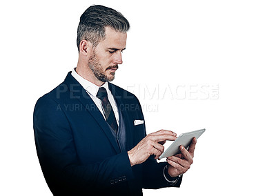 Buy stock photo Studio shot of a businessman using a digital tablet against a white background