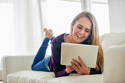 Buy stock photo Woman, home and relaxing in living room with tablet for social media, online post and watch videos. Female person, couch and smile or laugh in lounge for entertainment, streaming service and website