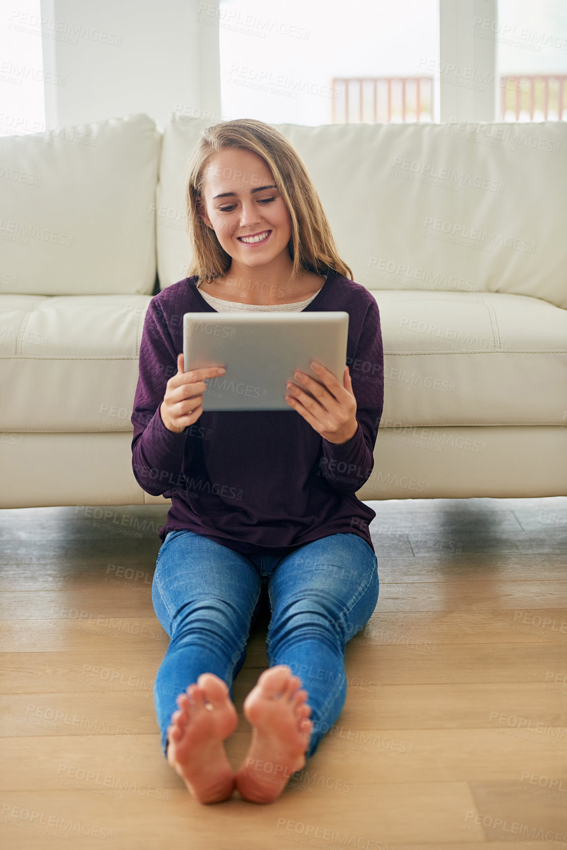 Buy stock photo Woman, home and relaxing on floor with tablet for social media, online post or watch videos for fun. Female person, couch and smile or laugh in lounge for entertainment, streaming service and website