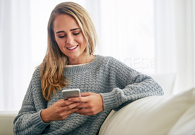 Buy stock photo Woman, home and relaxing on couch with smartphone for social media, online post and watch videos for fun. Girl, sofa and smile or laugh in lounge for entertainment, streaming service and website