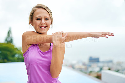 Buy stock photo Cropped shot of a young woman doing stretch exercises