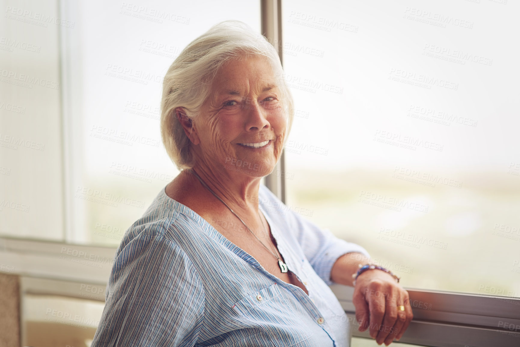 Buy stock photo Portrait, senior woman and relax by window of retirement home for peace, memories or nostalgia with Alzheimer morning. Smile, elderly and wellness for calm, remember or future hope at nursing centre