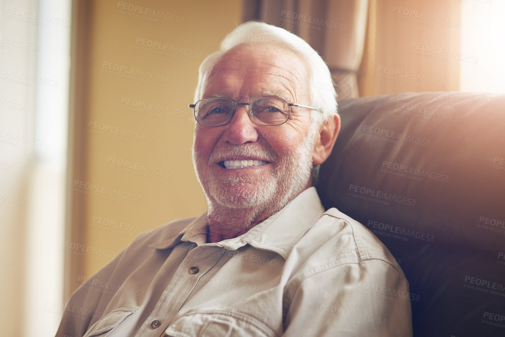 Buy stock photo Portrait, elderly man and smile on sofa in living room for relax, retirement or good mood. Happiness, pensioner and senior person with wisdom for confidence, comfortable or satisfaction in home